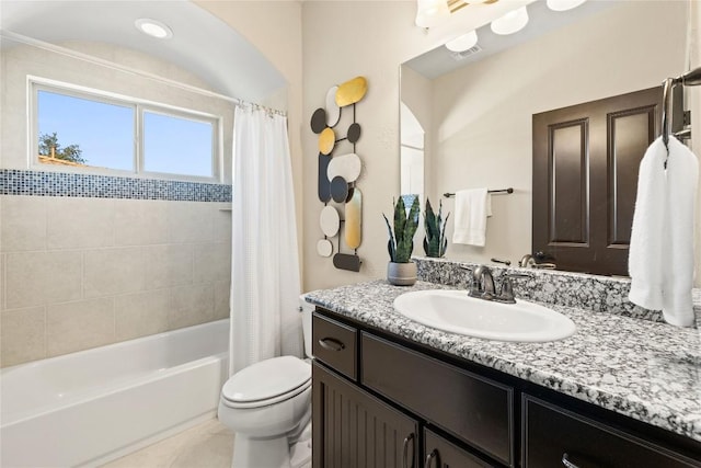 full bathroom featuring tile patterned floors, shower / bath combination with curtain, toilet, and vanity