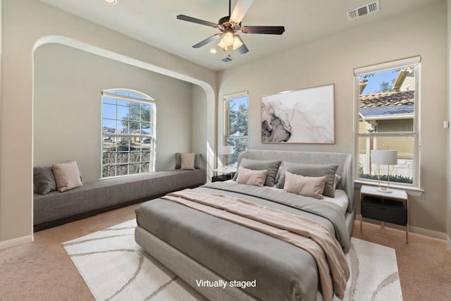 carpeted bedroom featuring baseboards, visible vents, multiple windows, and recessed lighting