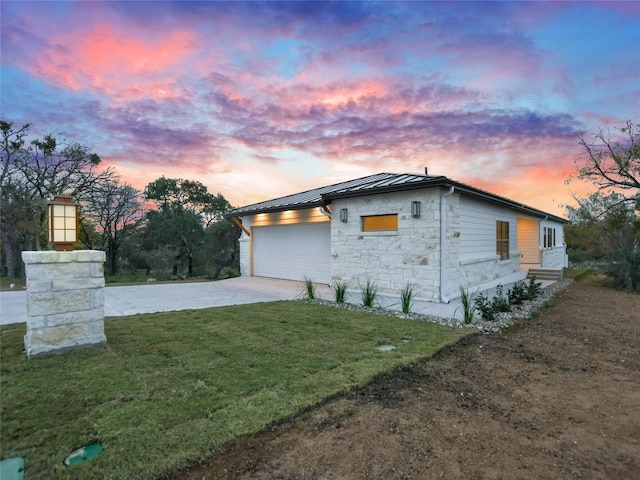 property exterior at dusk with a yard and a garage