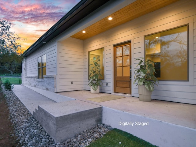 view of exterior entry at dusk