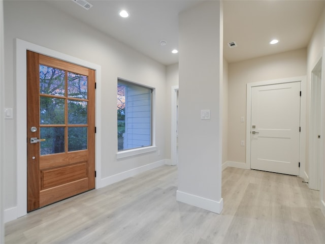 doorway to outside with plenty of natural light and light wood-type flooring