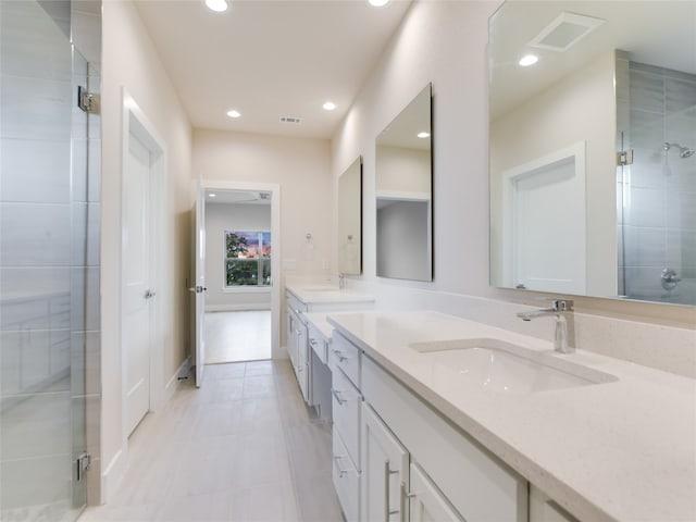 bathroom featuring tile floors, dual bowl vanity, and walk in shower