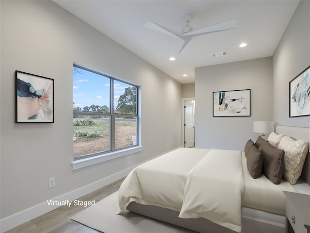 bedroom with ceiling fan and light hardwood / wood-style floors