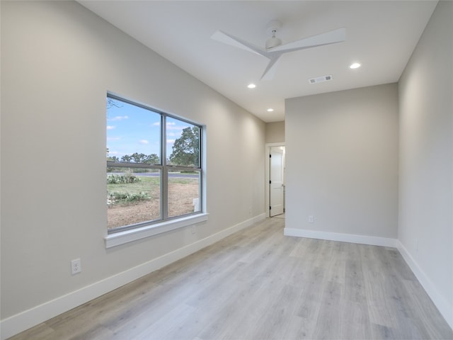 spare room featuring light hardwood / wood-style floors and ceiling fan