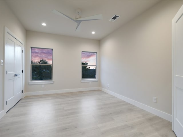 unfurnished room featuring light wood-type flooring and a wealth of natural light