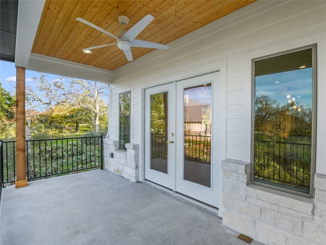 view of terrace featuring ceiling fan and french doors