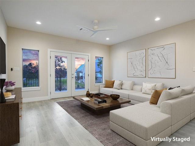 living room with ceiling fan, light wood-type flooring, and french doors