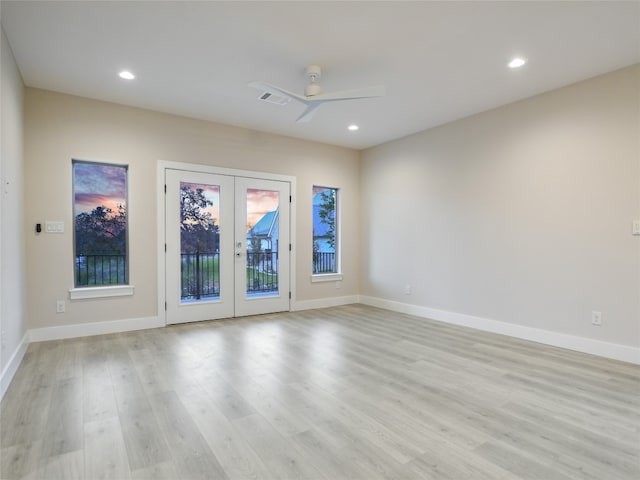 unfurnished room featuring light hardwood / wood-style floors, ceiling fan, and french doors