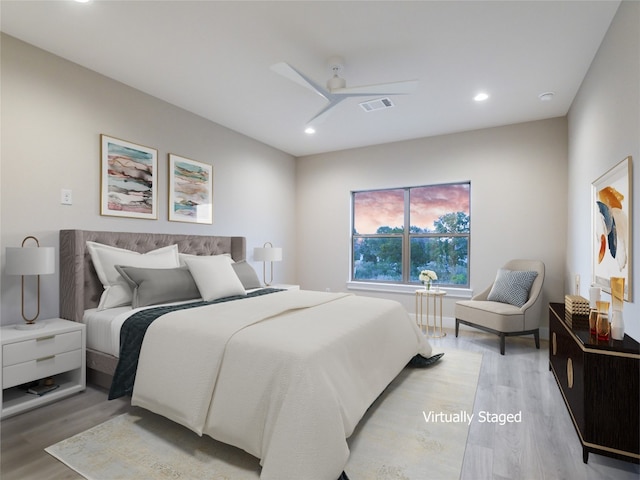 bedroom with ceiling fan and light hardwood / wood-style flooring