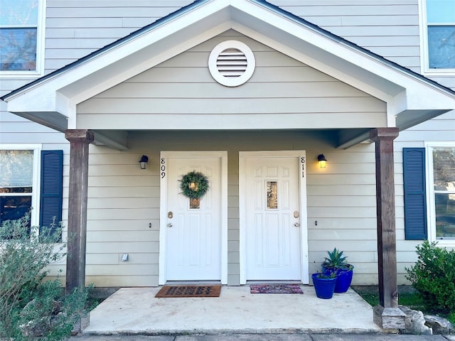 view of exterior entry with covered porch