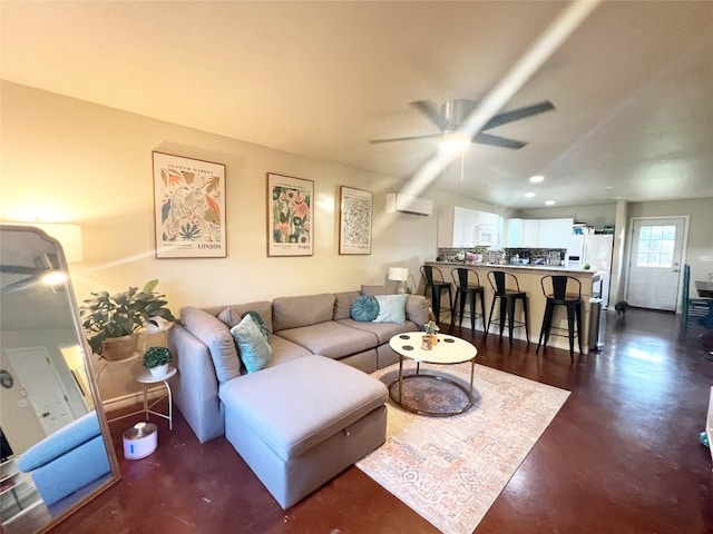 living room with ceiling fan and a wall unit AC