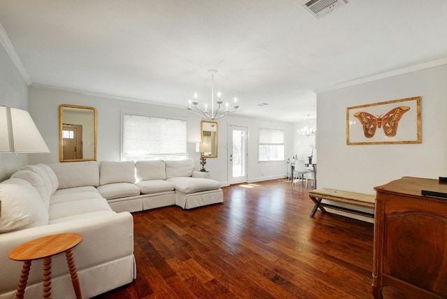 living room featuring ornamental molding, dark wood-type flooring, and a chandelier