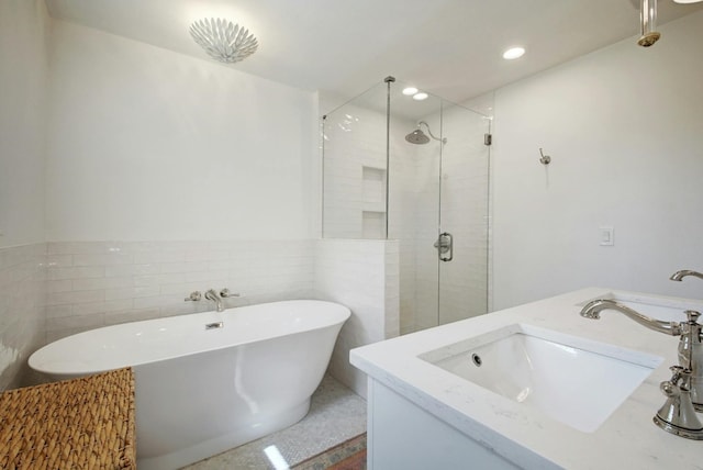 bathroom featuring tile walls and separate shower and tub