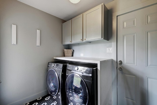 laundry area featuring cabinets and washer and clothes dryer