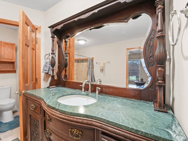 bathroom featuring tile patterned floors, a shower with curtain, vanity, and toilet