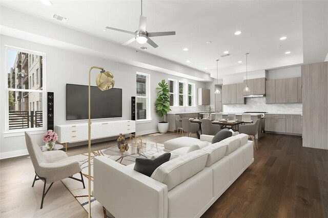 living room with ceiling fan and dark hardwood / wood-style floors