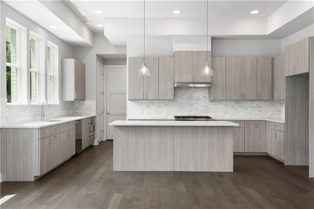 kitchen featuring dark hardwood / wood-style floors, tasteful backsplash, decorative light fixtures, and a center island