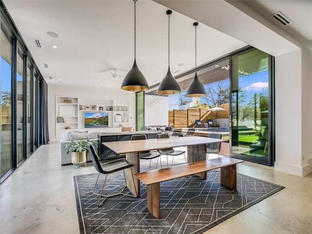 dining space with concrete floors and expansive windows