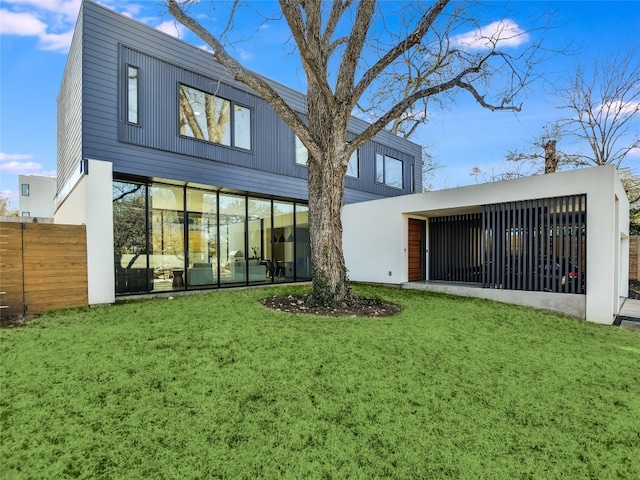 rear view of house with a lawn