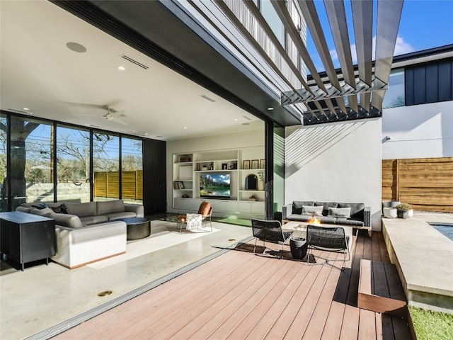 wooden deck featuring an outdoor living space, a pergola, and ceiling fan