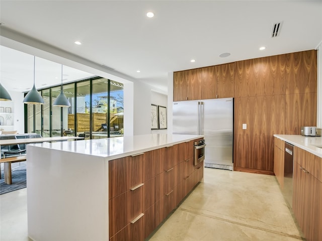 kitchen featuring wooden walls, a center island, and appliances with stainless steel finishes