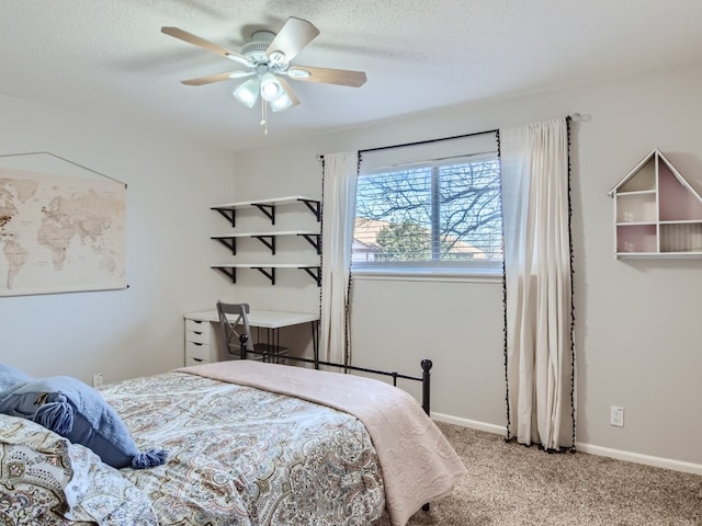 bedroom with a textured ceiling, carpet, and ceiling fan