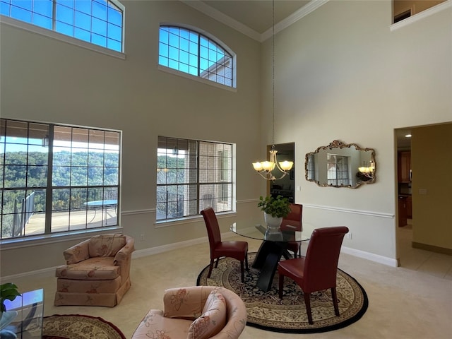 carpeted dining space featuring a chandelier, a towering ceiling, and ornamental molding