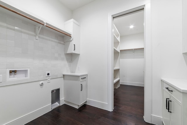 washroom featuring hookup for an electric dryer, cabinets, dark wood-type flooring, and washer hookup