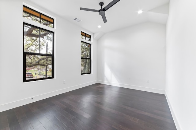 empty room with a wealth of natural light, dark hardwood / wood-style flooring, and ceiling fan