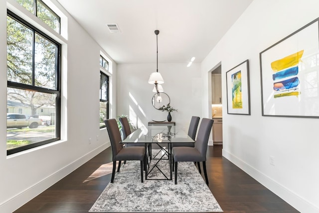 dining area with dark hardwood / wood-style flooring