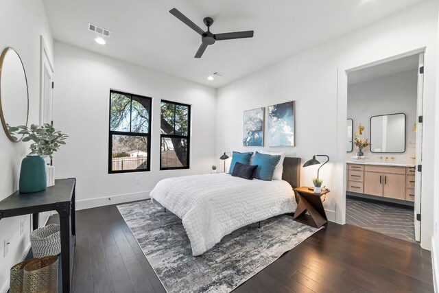 bedroom featuring connected bathroom, ceiling fan, and dark wood-type flooring