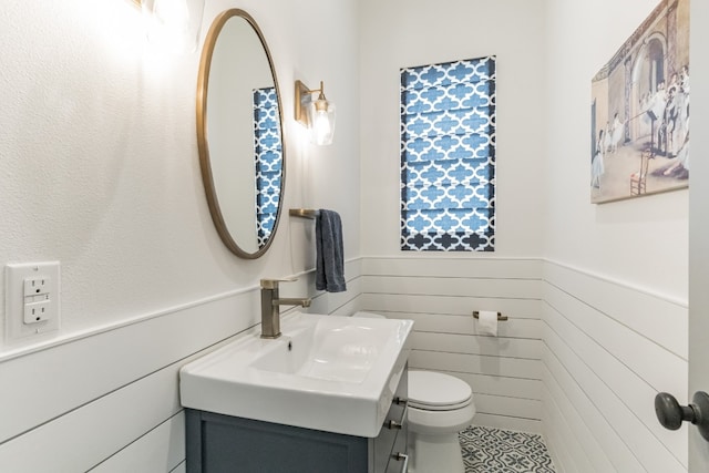 bathroom featuring toilet and large vanity