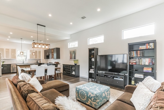 living room with dark hardwood / wood-style flooring and sink