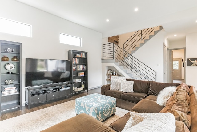 living room with dark hardwood / wood-style floors and a wealth of natural light