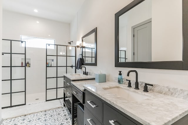 bathroom with an enclosed shower, double sink, tile floors, and oversized vanity