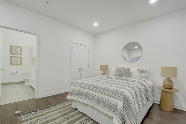 4361 S Congress Ave Unit 408, Austin, TX 78745 - bedroom with baseboards, wood finished floors, recessed lighting, connected bathroom, and a closet