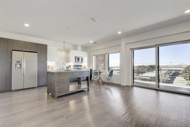4361 S Congress Ave Unit 408, Austin, TX 78745 - kitchen with stainless steel appliances, a sink, plenty of natural light, modern cabinets, and recessed lighting