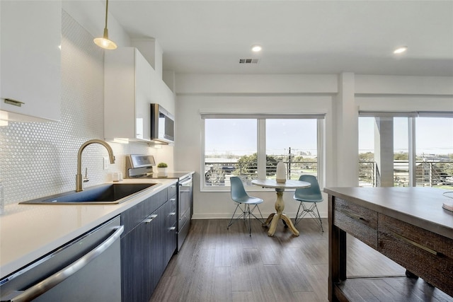 4361 S Congress Ave Unit 408, Austin, TX 78745 - kitchen featuring appliances with stainless steel finishes, healthy amount of natural light, light countertops, a sink, and recessed lighting