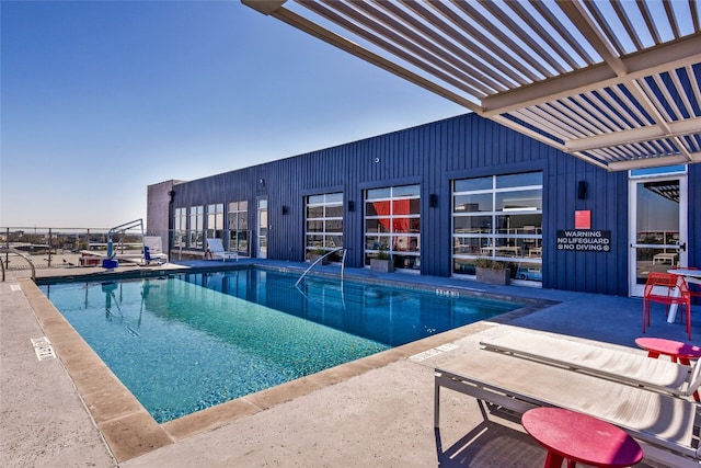 view of swimming pool with a pergola and a patio