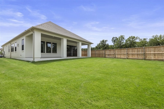 rear view of property with a patio and a yard