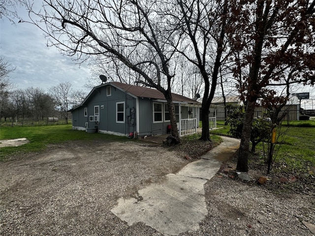 rear view of property featuring a yard