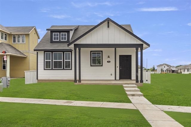 view of front of house with a porch and a front yard