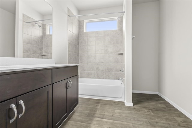 bathroom with vanity, hardwood / wood-style floors, and tiled shower / bath combo