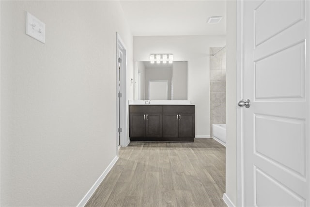 hall featuring light hardwood / wood-style floors and sink