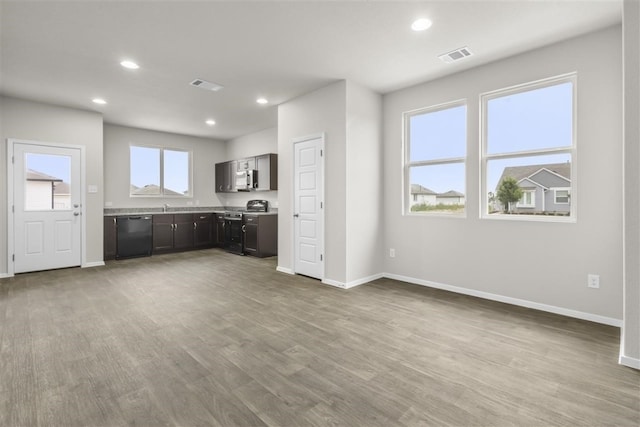 kitchen featuring dark brown cabinetry, light hardwood / wood-style floors, stainless steel range with electric stovetop, and black dishwasher