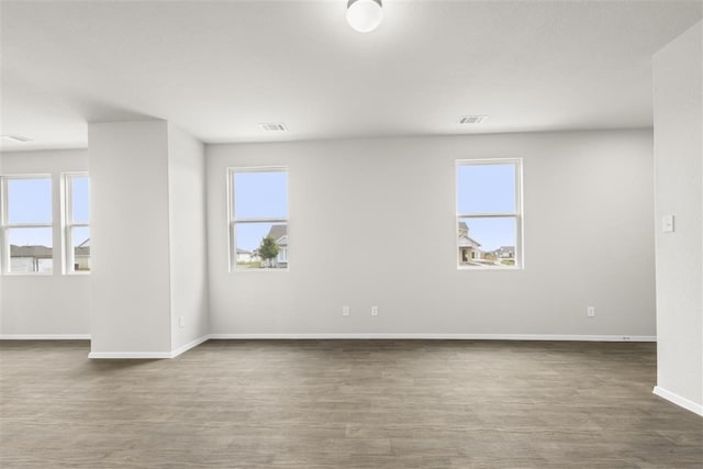 spare room with dark wood-type flooring