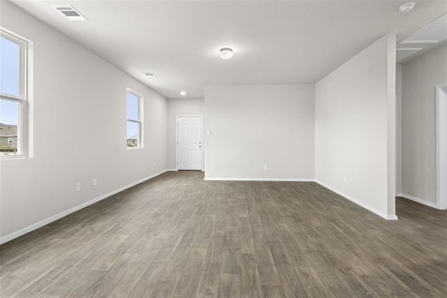 empty room with dark hardwood / wood-style flooring