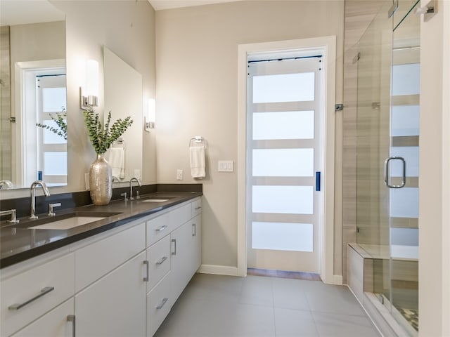 bathroom with tile floors, an enclosed shower, and double vanity