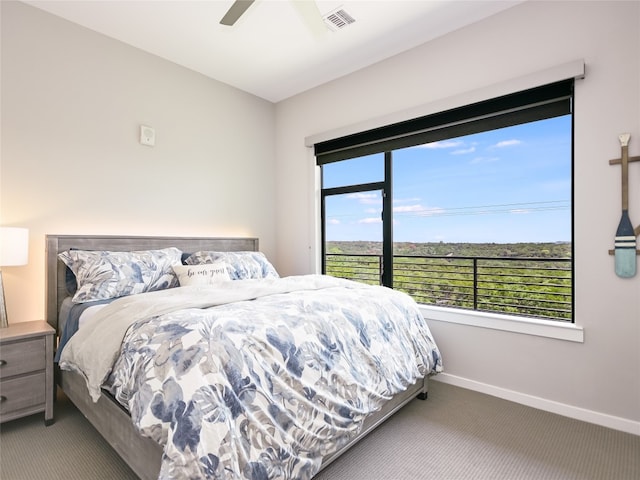 carpeted bedroom featuring ceiling fan and multiple windows