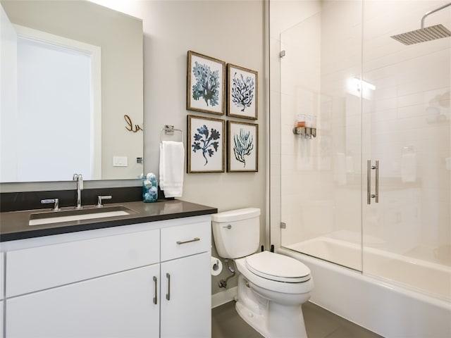 full bathroom featuring bath / shower combo with glass door, toilet, and large vanity